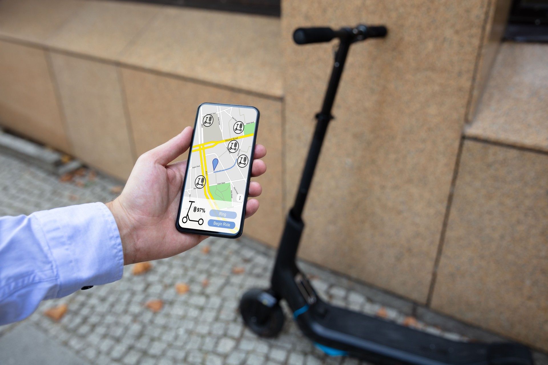 Young Man Using Electric Scooter Ride Sharing App