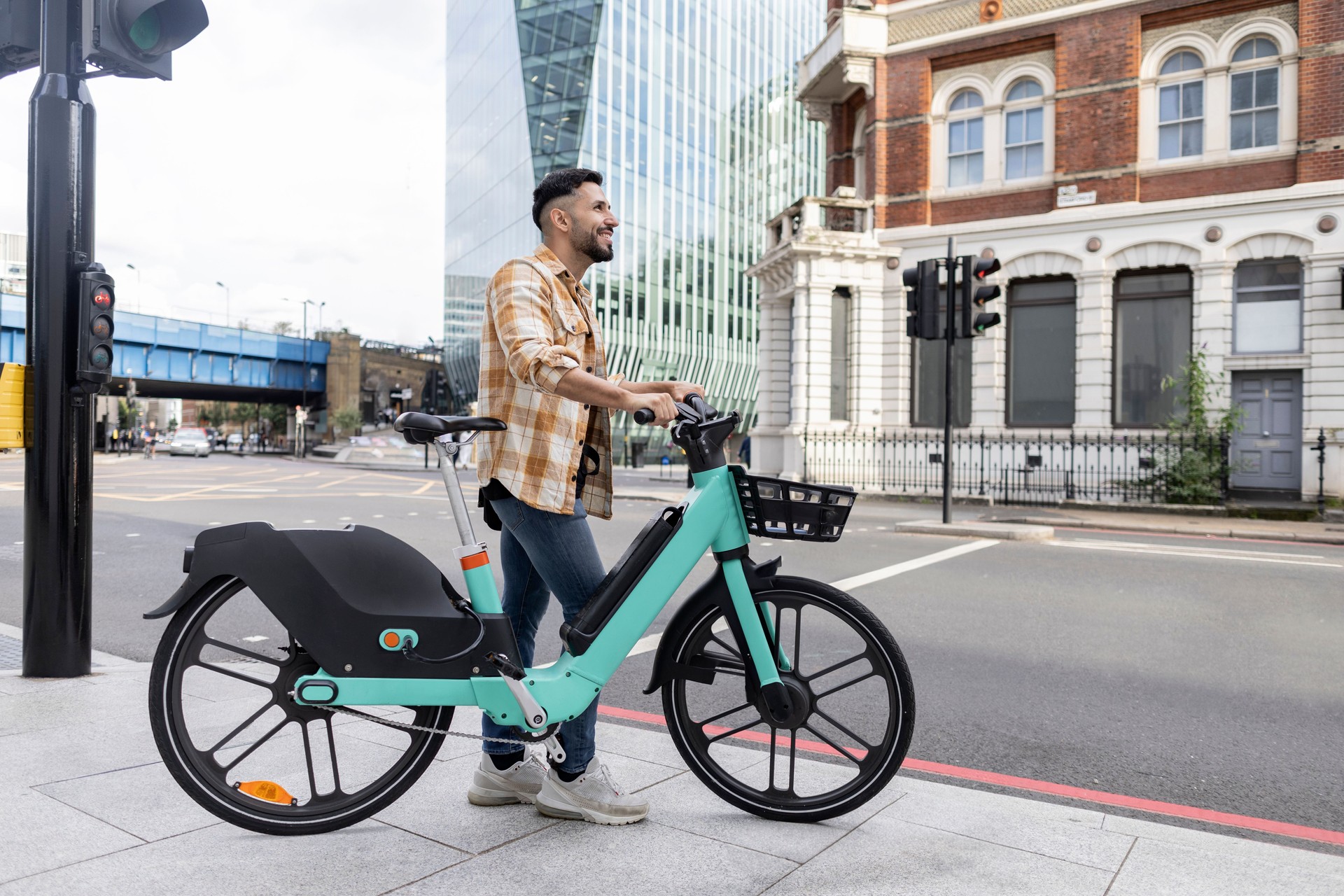 attractive hispanic man with his rented e-bike touring the city